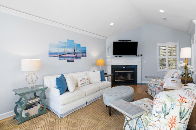 living room with baseboards, visible vents, a tiled fireplace, wood finished floors, and vaulted ceiling