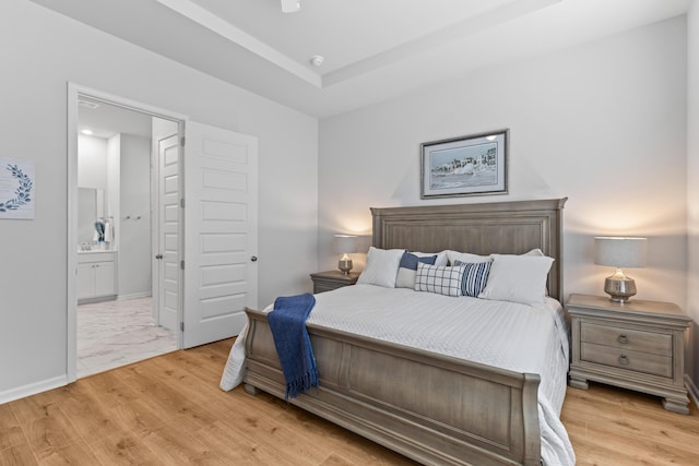 1107 Bellwether Ln, Summerville, SC 29485 - bedroom with light wood finished floors, connected bathroom, and a raised ceiling