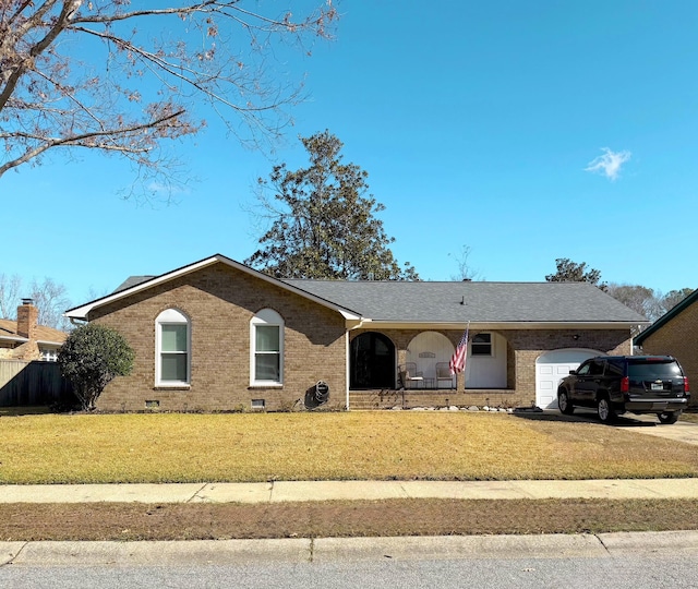 single story home featuring a front lawn and a garage