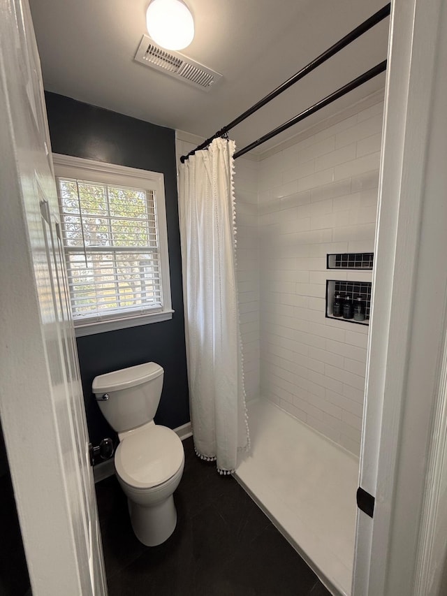 bathroom with curtained shower and toilet