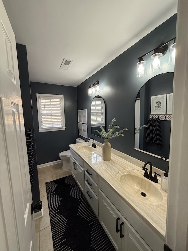 bathroom featuring toilet, vanity, tile patterned floors, and plenty of natural light