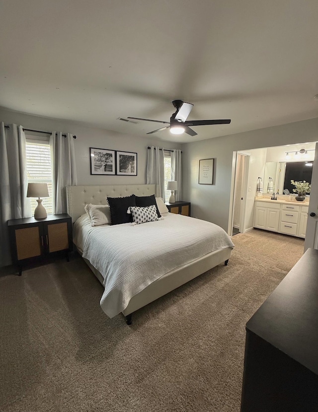 bedroom featuring carpet flooring, ensuite bath, and ceiling fan