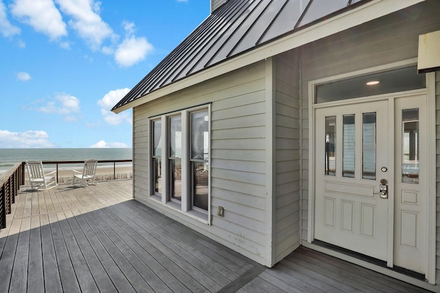 deck with a beach view and a water view