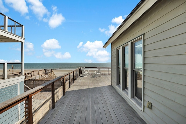 deck featuring a water view and a view of the beach