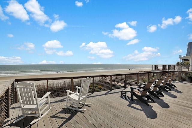 deck featuring a water view and a view of the beach