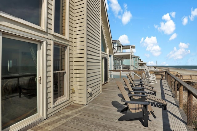 wooden terrace featuring a water view