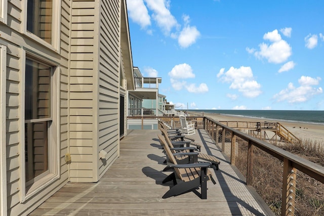 balcony with a water view and a beach view