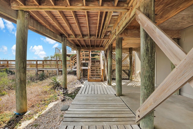 view of patio / terrace featuring fence and stairway