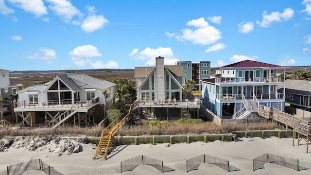 back of house featuring stairway and a residential view