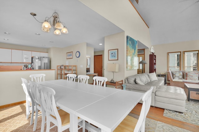 dining space featuring recessed lighting, a notable chandelier, and light wood-style flooring