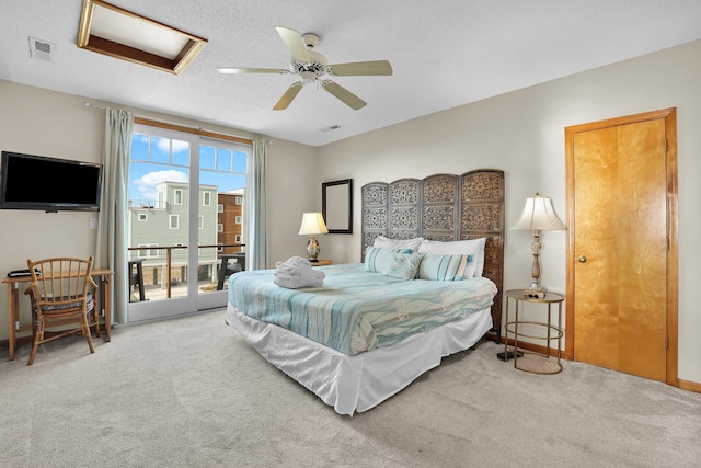 bedroom featuring access to exterior, attic access, carpet flooring, and visible vents