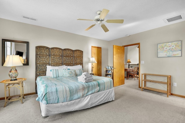 bedroom with carpet floors, baseboards, visible vents, and a ceiling fan