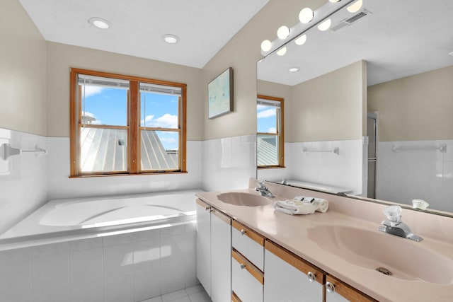 full bathroom featuring a sink, visible vents, and a healthy amount of sunlight