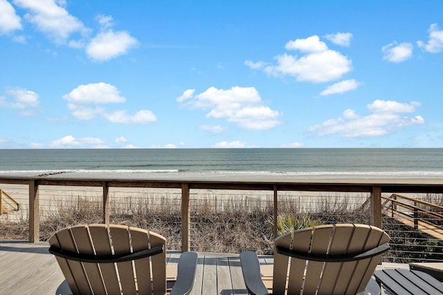 deck featuring a view of the beach and a water view