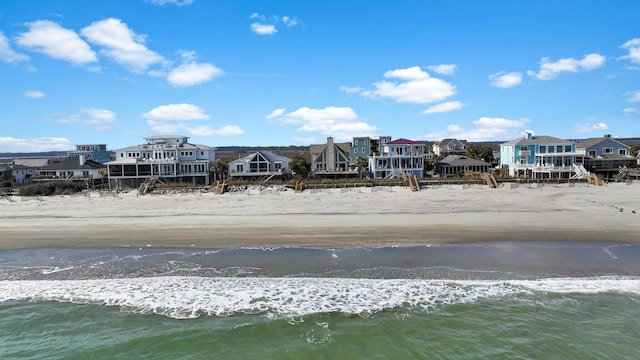 exterior space featuring a water view, a residential view, and a view of the beach