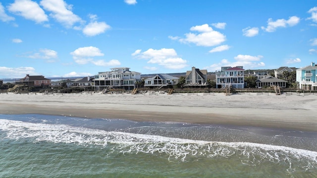 exterior space with a residential view and a view of the beach