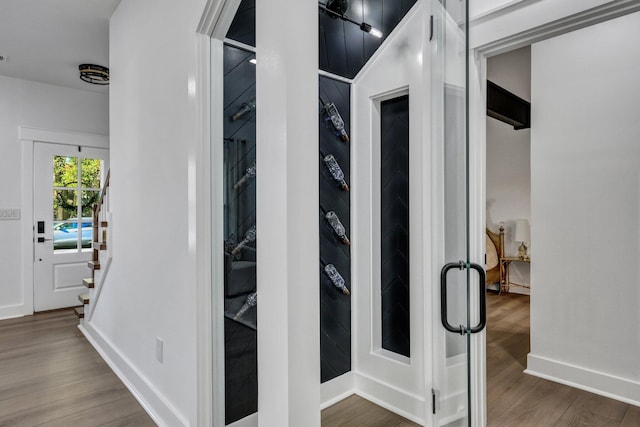 hallway with hardwood / wood-style floors