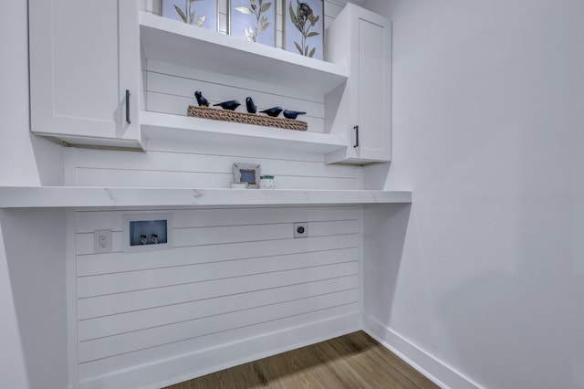 bar featuring dark hardwood / wood-style floors and white cabinetry