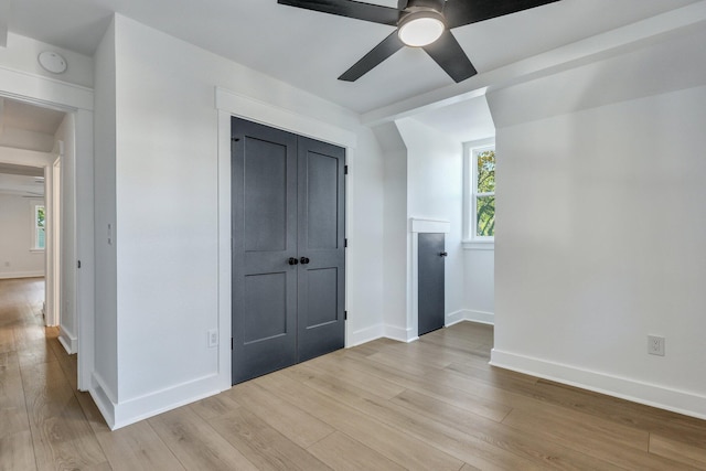 interior space featuring ceiling fan, a closet, and light wood-type flooring