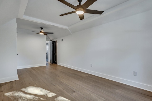 empty room with light hardwood / wood-style floors, vaulted ceiling, and ceiling fan