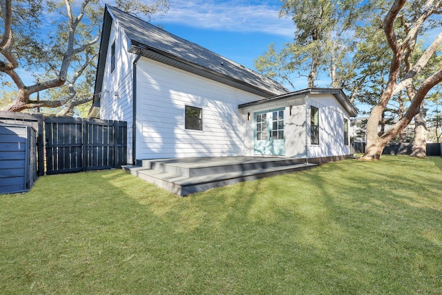 back of house with a yard and a wooden deck