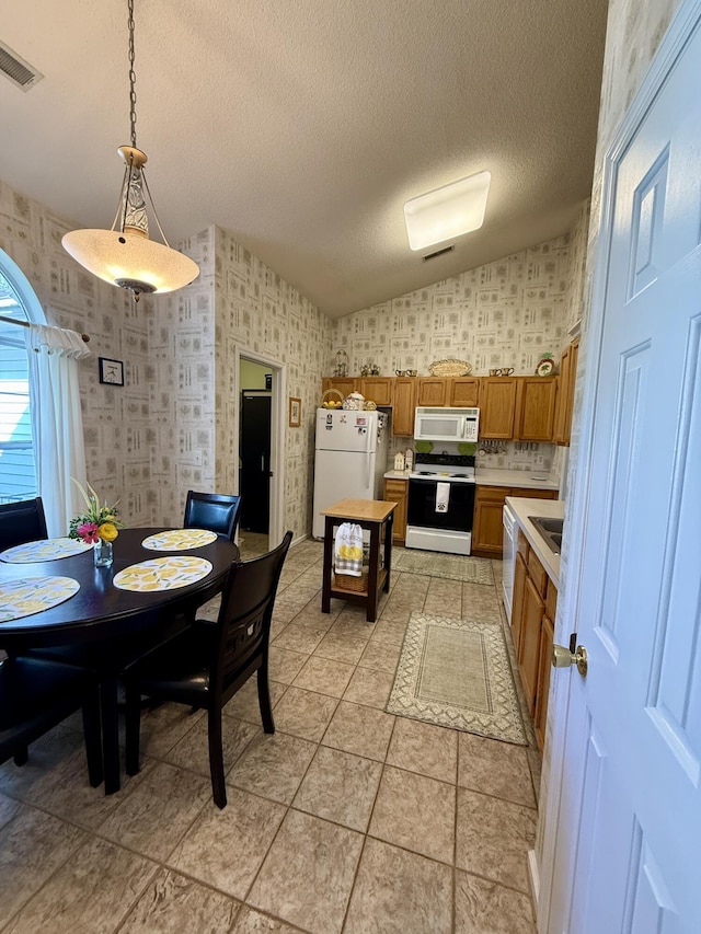 3415 Pawtucket St, Charleston, SC 29414 - kitchen with white appliances, light countertops, brown cabinets, wallpapered walls, and a sink