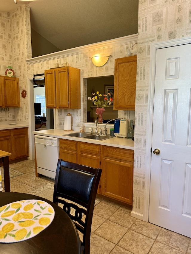 3415 Pawtucket St, Charleston, SC 29414 - kitchen with white dishwasher, wallpapered walls, a sink, lofted ceiling, and light countertops