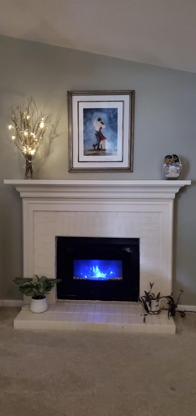 3415 Pawtucket St, Charleston, SC 29414 - detailed view of a glass covered fireplace, baseboards, and carpet flooring