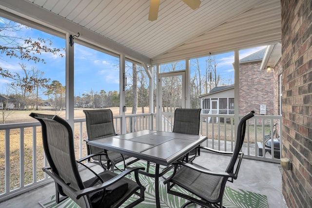 sunroom / solarium featuring ceiling fan and vaulted ceiling