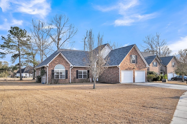 front facade with a front lawn and a garage