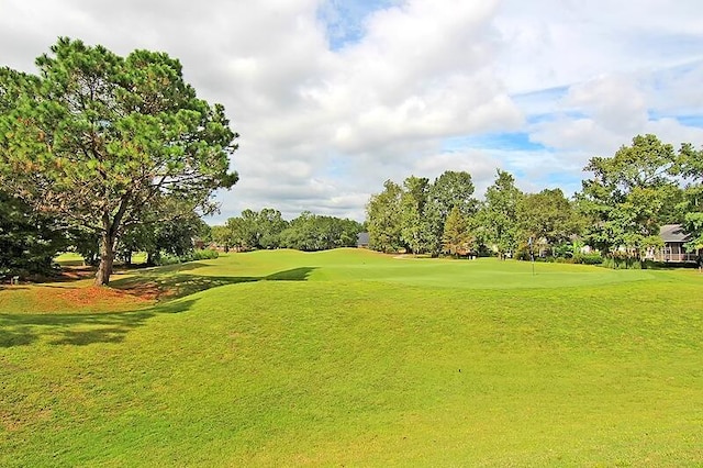 view of property's community with a lawn