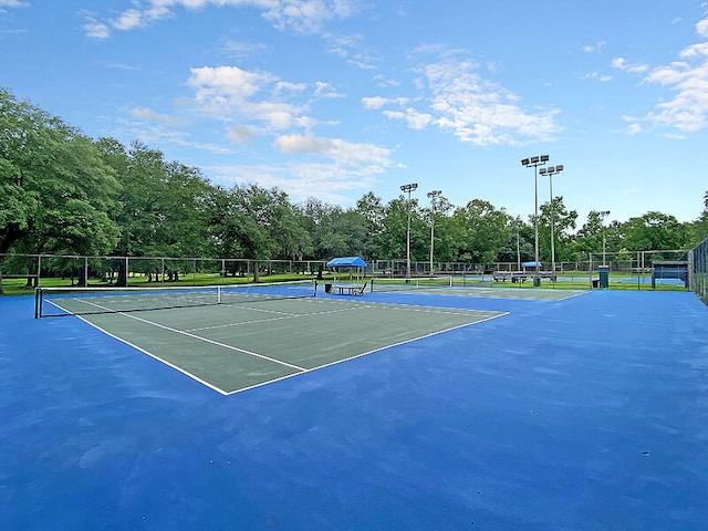 view of tennis court with basketball hoop