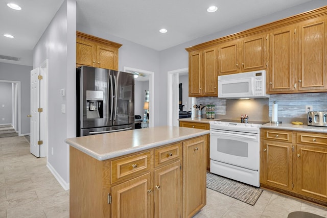 kitchen featuring backsplash, light tile patterned flooring, white appliances, and a kitchen island