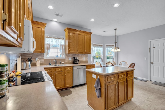 kitchen with tasteful backsplash, dishwasher, a notable chandelier, a center island, and sink