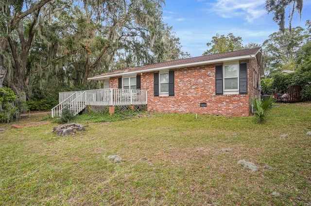 ranch-style house with a wooden deck and a front lawn