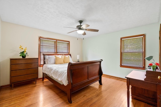 1900 Morgan Ave, North Charleston, SC 29406 - bedroom with multiple windows, light wood-style floors, a textured ceiling, and a ceiling fan