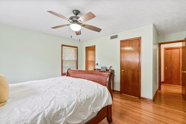 1900 Morgan Ave, North Charleston, SC 29406 - bedroom with light wood finished floors, two closets, and a ceiling fan