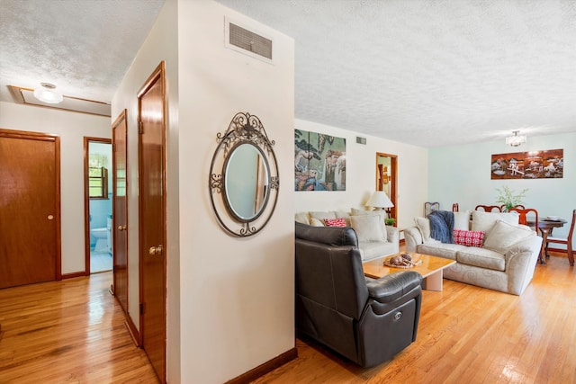 1900 Morgan Ave, North Charleston, SC 29406 - living room featuring a textured ceiling and light wood-style floors