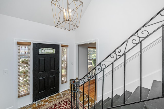 entrance foyer featuring a notable chandelier and a towering ceiling