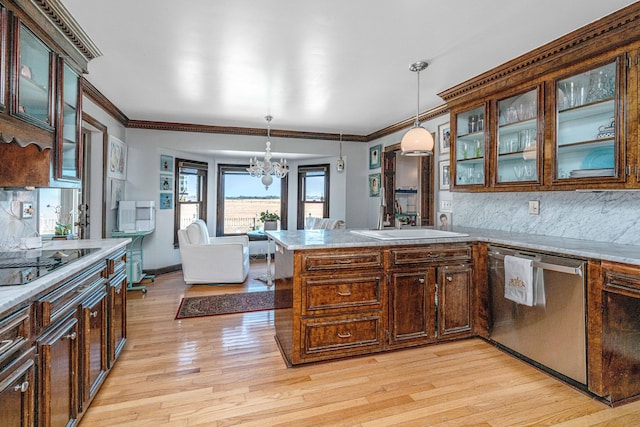 kitchen with pendant lighting, light hardwood / wood-style flooring, black electric cooktop, and dishwasher