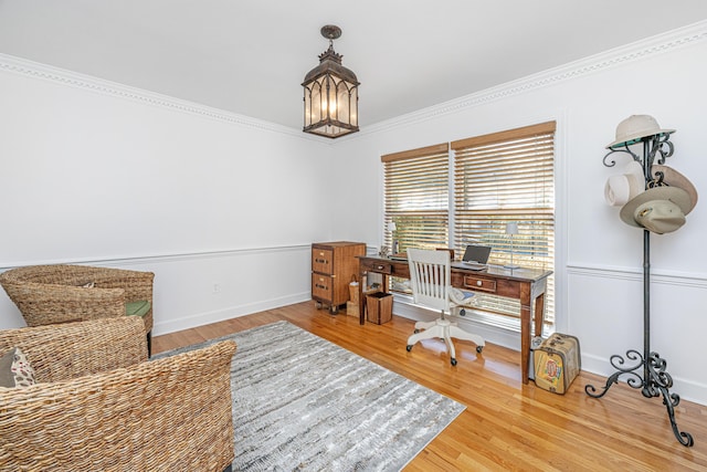 office area with crown molding, a notable chandelier, and hardwood / wood-style flooring