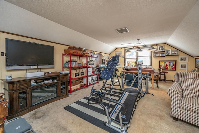 workout area featuring lofted ceiling, light colored carpet, and a textured ceiling