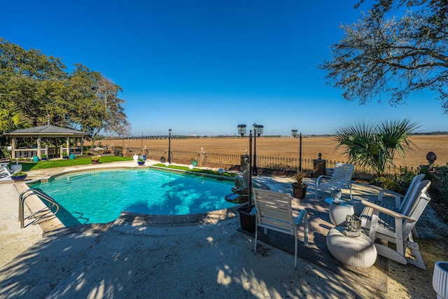 view of pool featuring a gazebo and a rural view