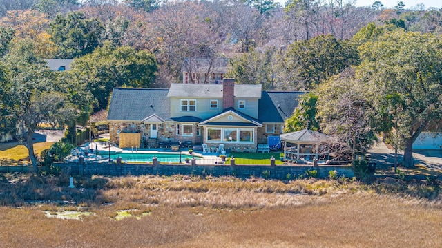 back of house with a gazebo and a patio