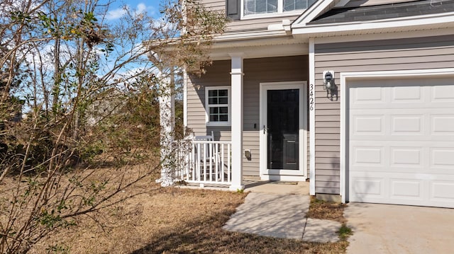 property entrance featuring a garage and covered porch