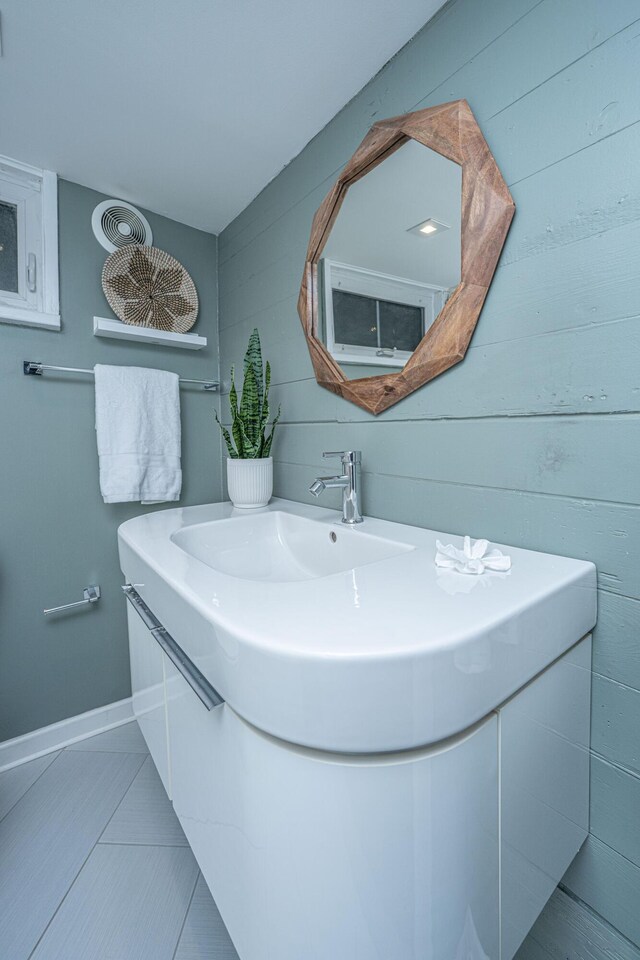 173 Fishburne St, Charleston, SC 29403 - bathroom with vanity, baseboards, and wooden walls