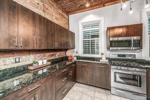 173 Fishburne St, Charleston, SC 29403 - kitchen with stainless steel appliances, wood ceiling, light tile patterned floors, dark stone counters, and dark brown cabinets