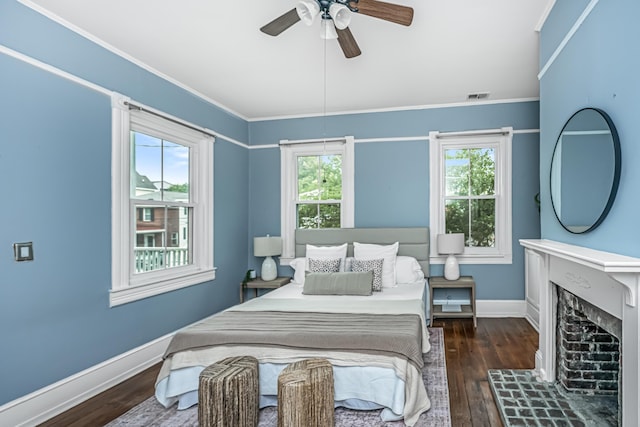 173 Fishburne St, Charleston, SC 29403 - bedroom with wood-type flooring, baseboards, crown molding, a ceiling fan, and a fireplace with raised hearth