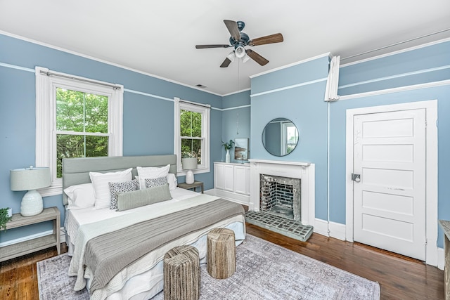 173 Fishburne St, Charleston, SC 29403 - bedroom featuring multiple windows, wood finished floors, a fireplace, crown molding, and baseboards