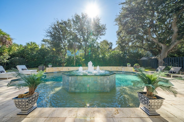 view of swimming pool with pool water feature